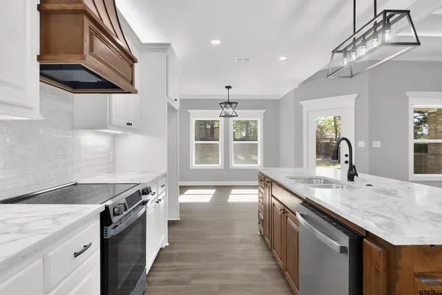 a kitchen with a stove sink and cabinets