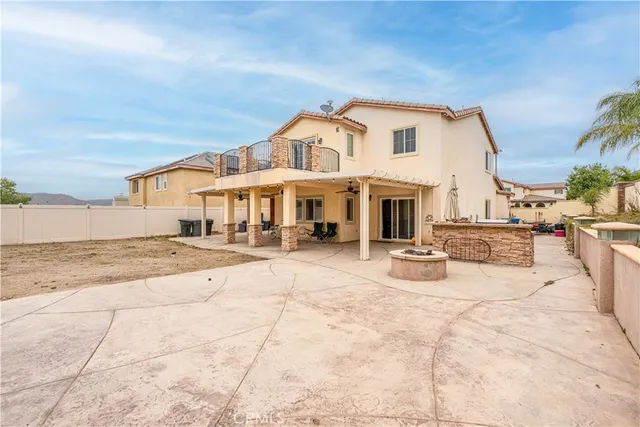 a view of a white house with swimming pool and sitting area