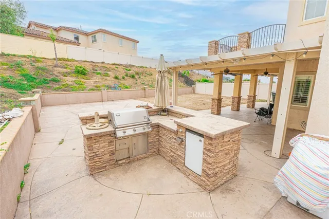 a view of kitchen with granite countertop lots of counter top space