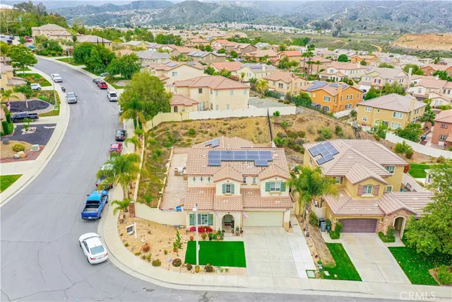 an aerial view of multiple houses with yard