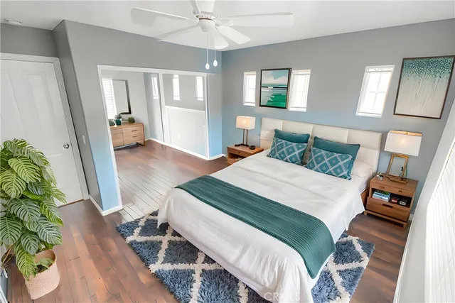a bedroom with a bed potted plant with the mirror