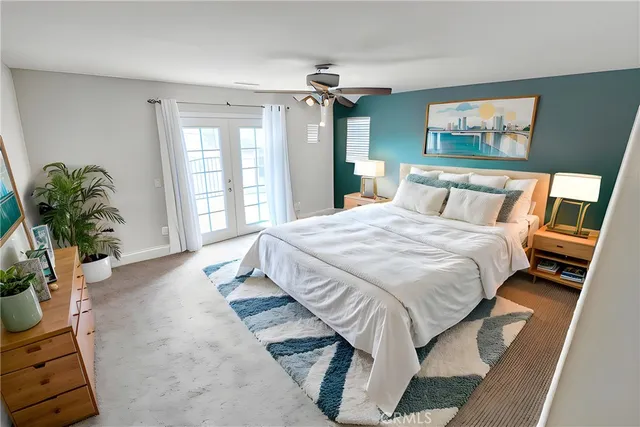 a spacious bedroom with a bed and a potted plant