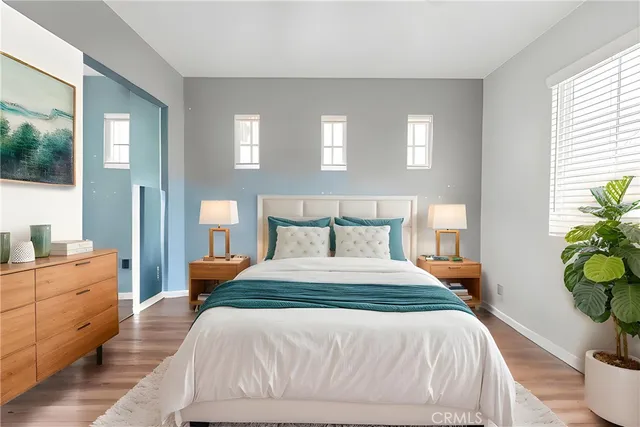 a bedroom with a bed and window with chair