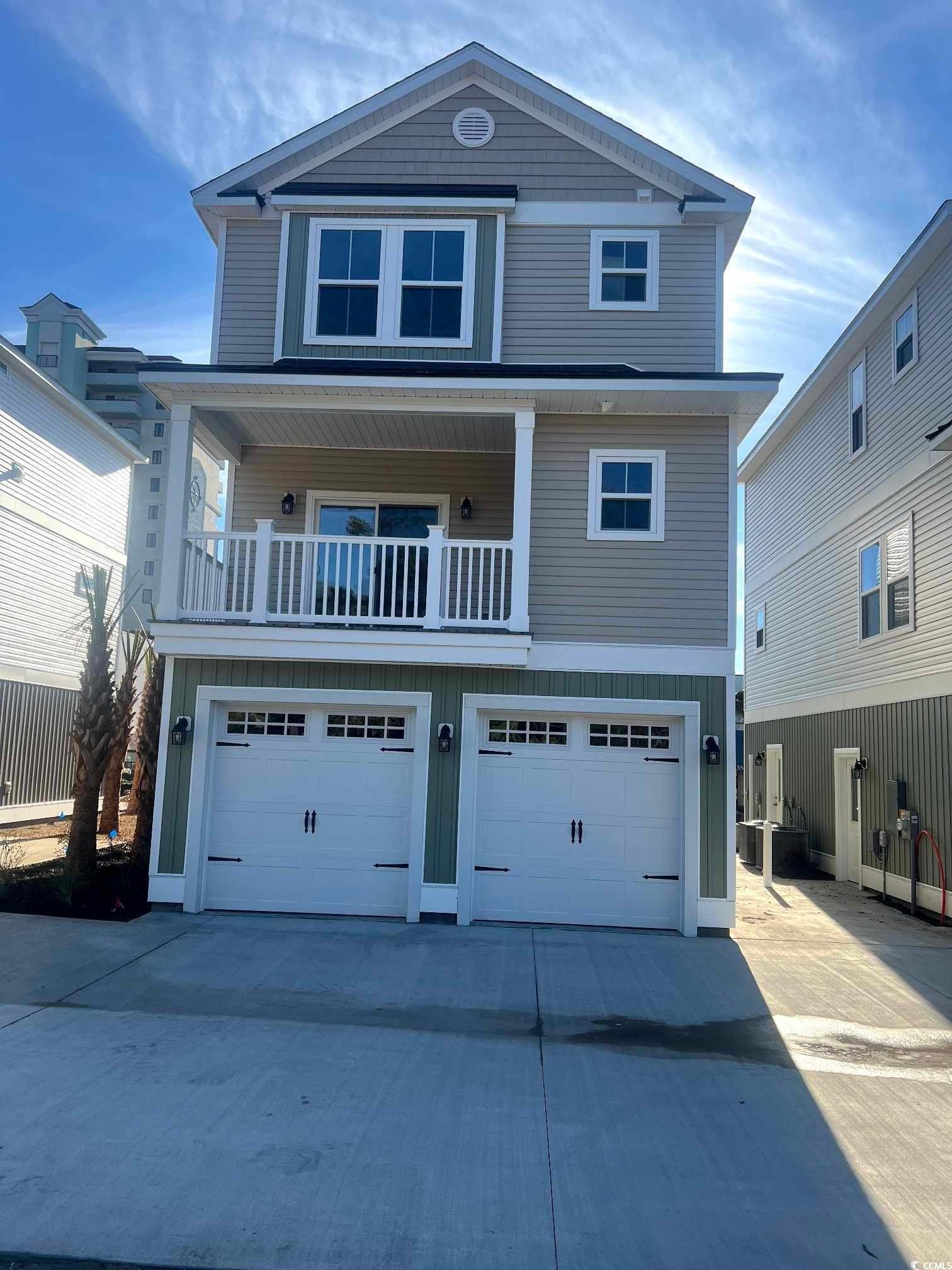 View of front of home featuring driveway, an attac
