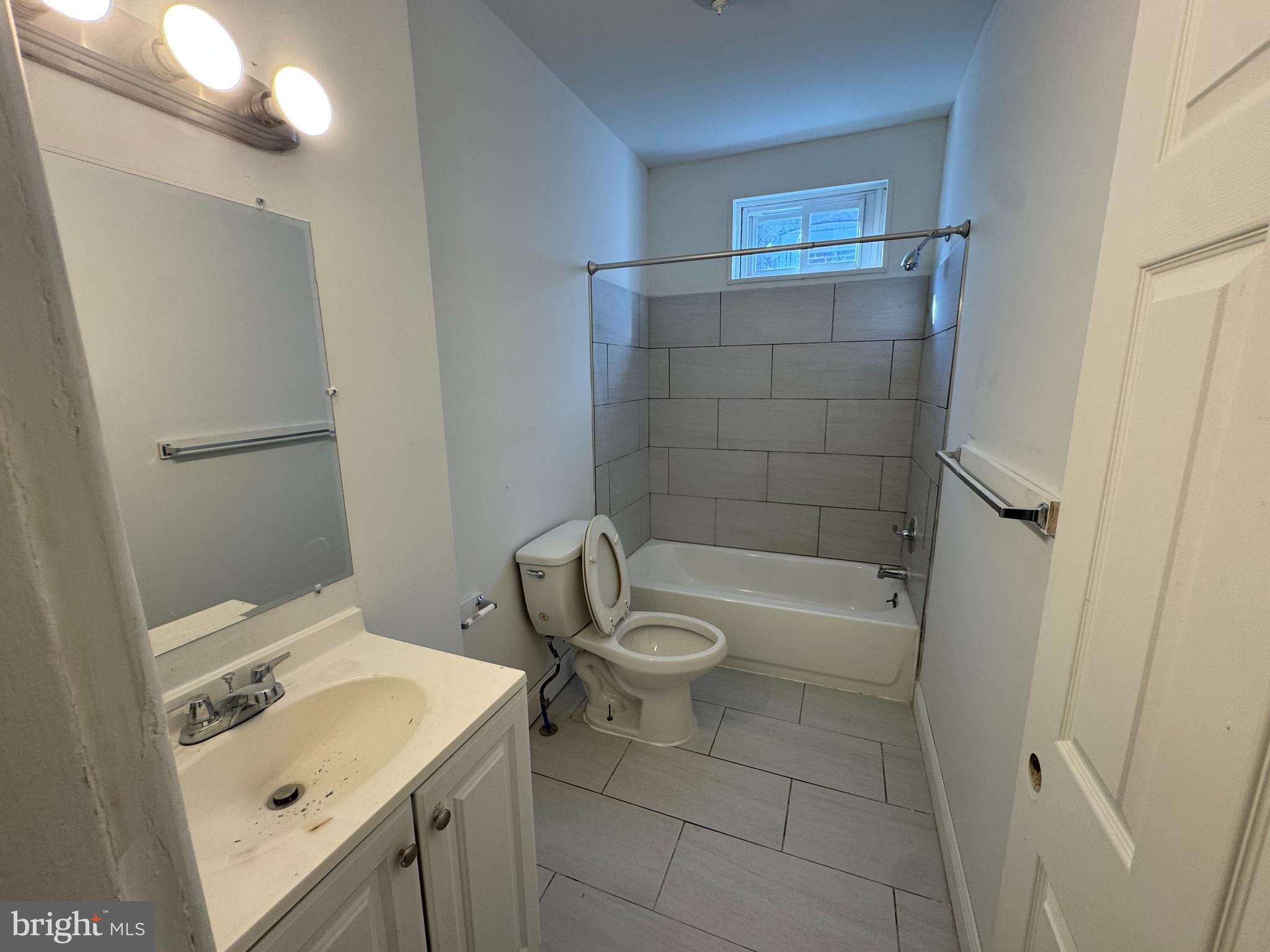 616 West 6th Street Chester, PA 19013 - Photo 13 of 15 a bathroom with a sink a toilet and shower
