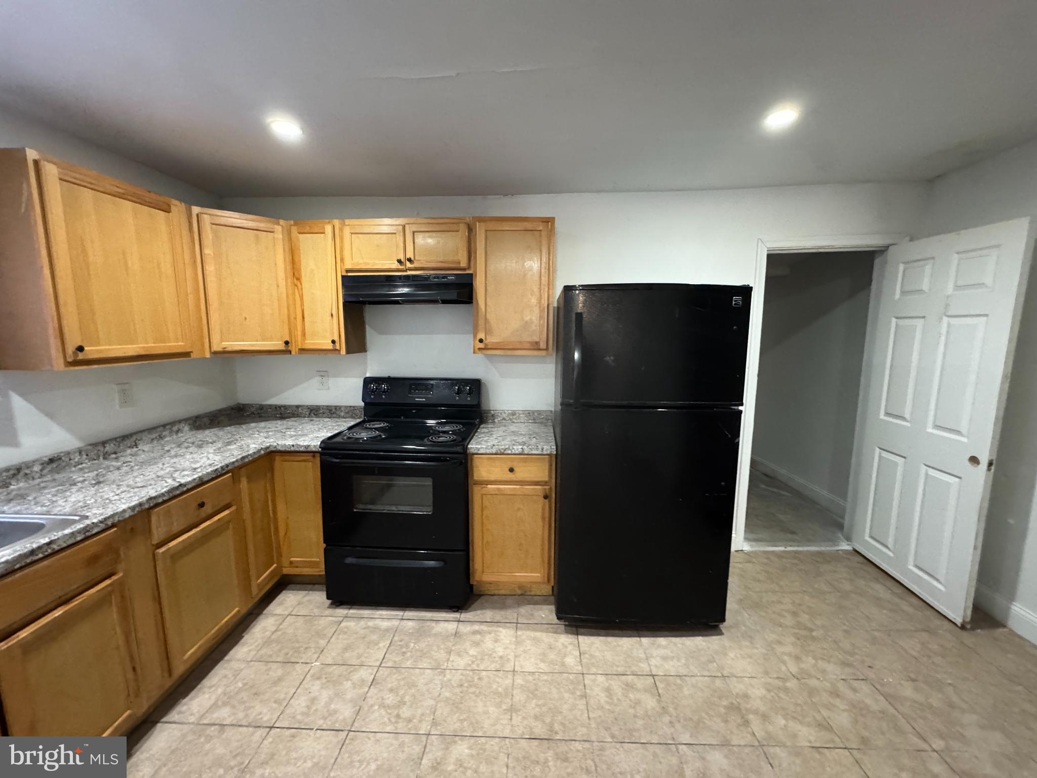 616 West 6th Street Chester, PA 19013 - Photo 7 of 15 a kitchen with a refrigerator and a sink