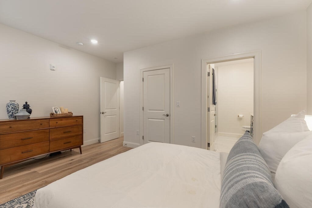 165 Cambridge Road, Unit 10 Woburn, MA 01801 - Photo 14 of 33 a bedroom with a bed and a dresser