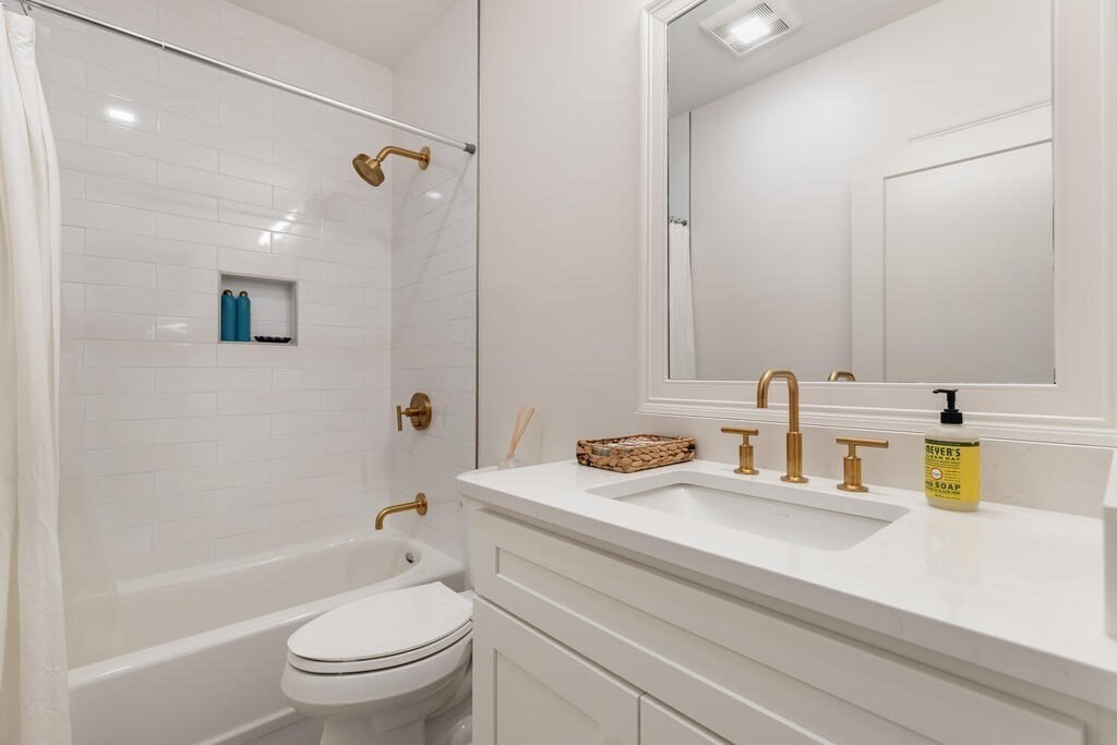 165 Cambridge Road, Unit 10 Woburn, MA 01801 - Photo 17 of 33 a bathroom with a granite countertop sink toilet and shower
