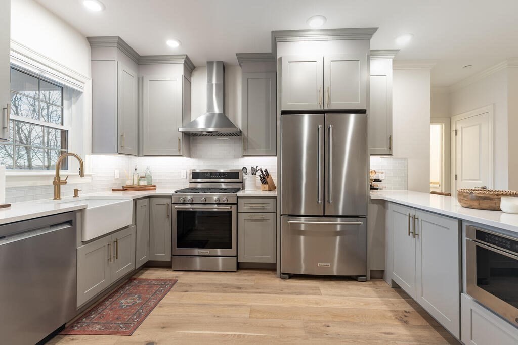 165 Cambridge Road, Unit 10 Woburn, MA 01801 - Photo 2 of 33 a kitchen with stainless steel appliances granite countertop a refrigerator stove and sink