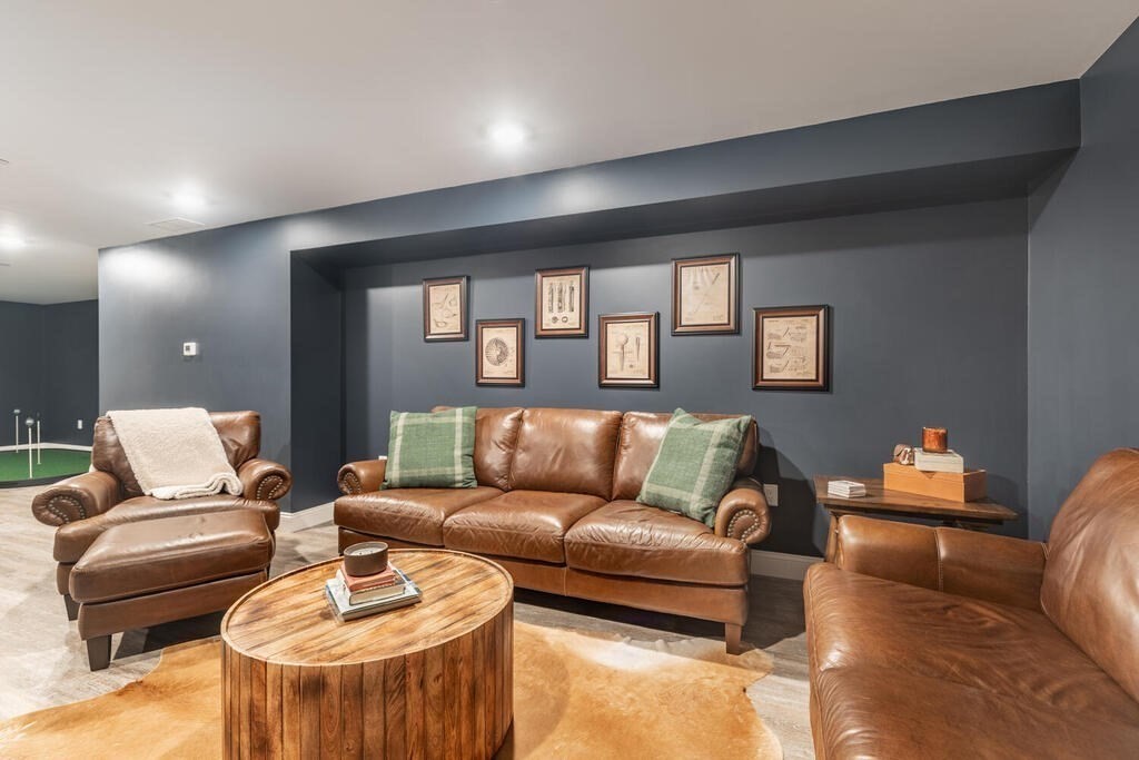 165 Cambridge Road, Unit 10 Woburn, MA 01801 - Photo 23 of 33 a living room with furniture and a wooden floor