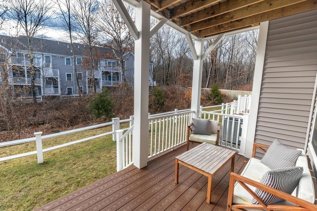 165 Cambridge Road, Unit 10 Woburn, MA 01801 - Photo 31 of 33 a view of balcony with wooden floor and outdoor seating
