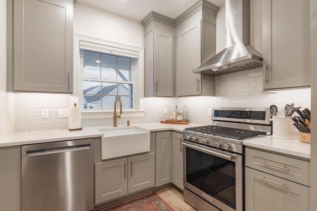 165 Cambridge Road, Unit 10 Woburn, MA 01801 - Photo 4 of 33 a kitchen with a stove sink and cabinets