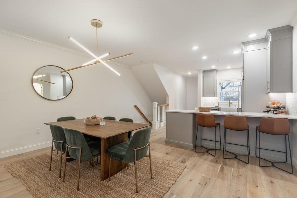 165 Cambridge Road, Unit 10 Woburn, MA 01801 - Photo 7 of 33 a view of a dining room with furniture and chandelier