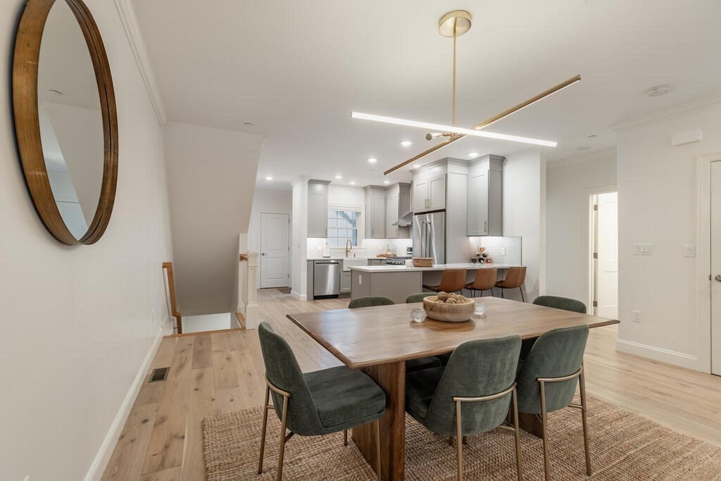 165 Cambridge Road, Unit 10 Woburn, MA 01801 - Photo 9 of 33 a dining room with furniture and a chandelier