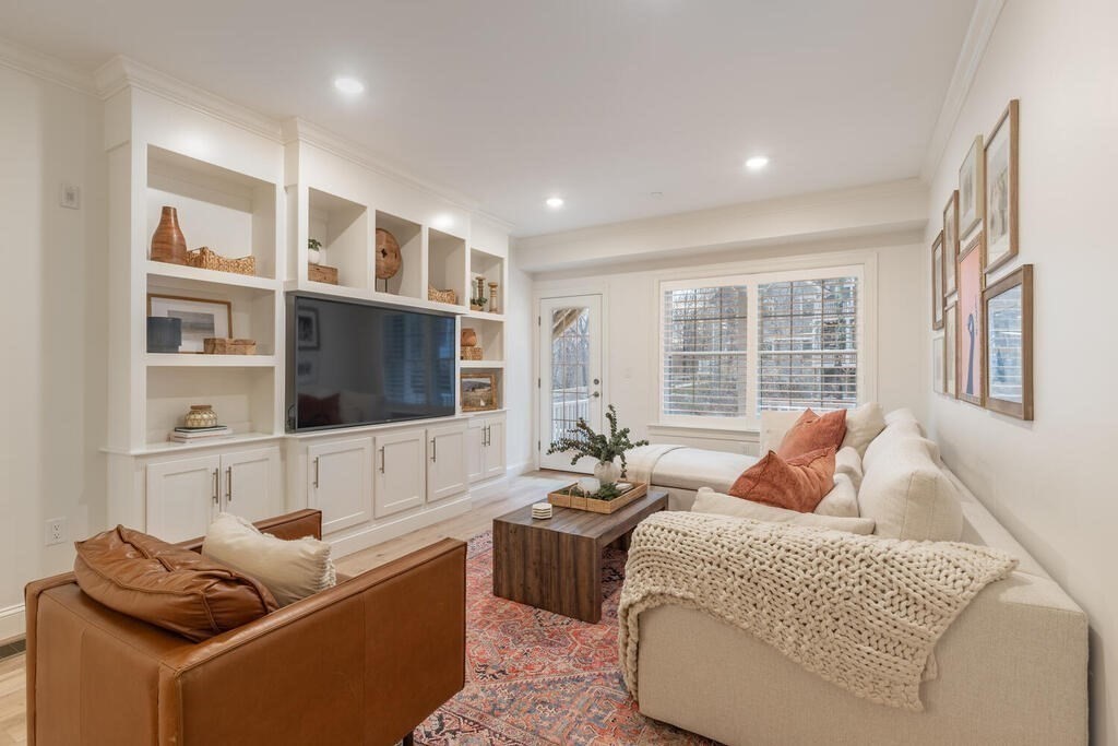 165 Cambridge Road, Unit 10 Woburn, MA 01801 - Photo 10 of 33 a living room with furniture and a flat screen tv
