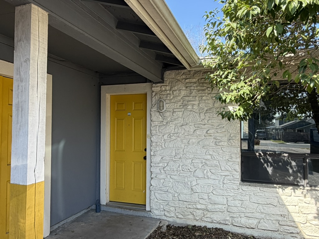 Entrance to property with stone siding