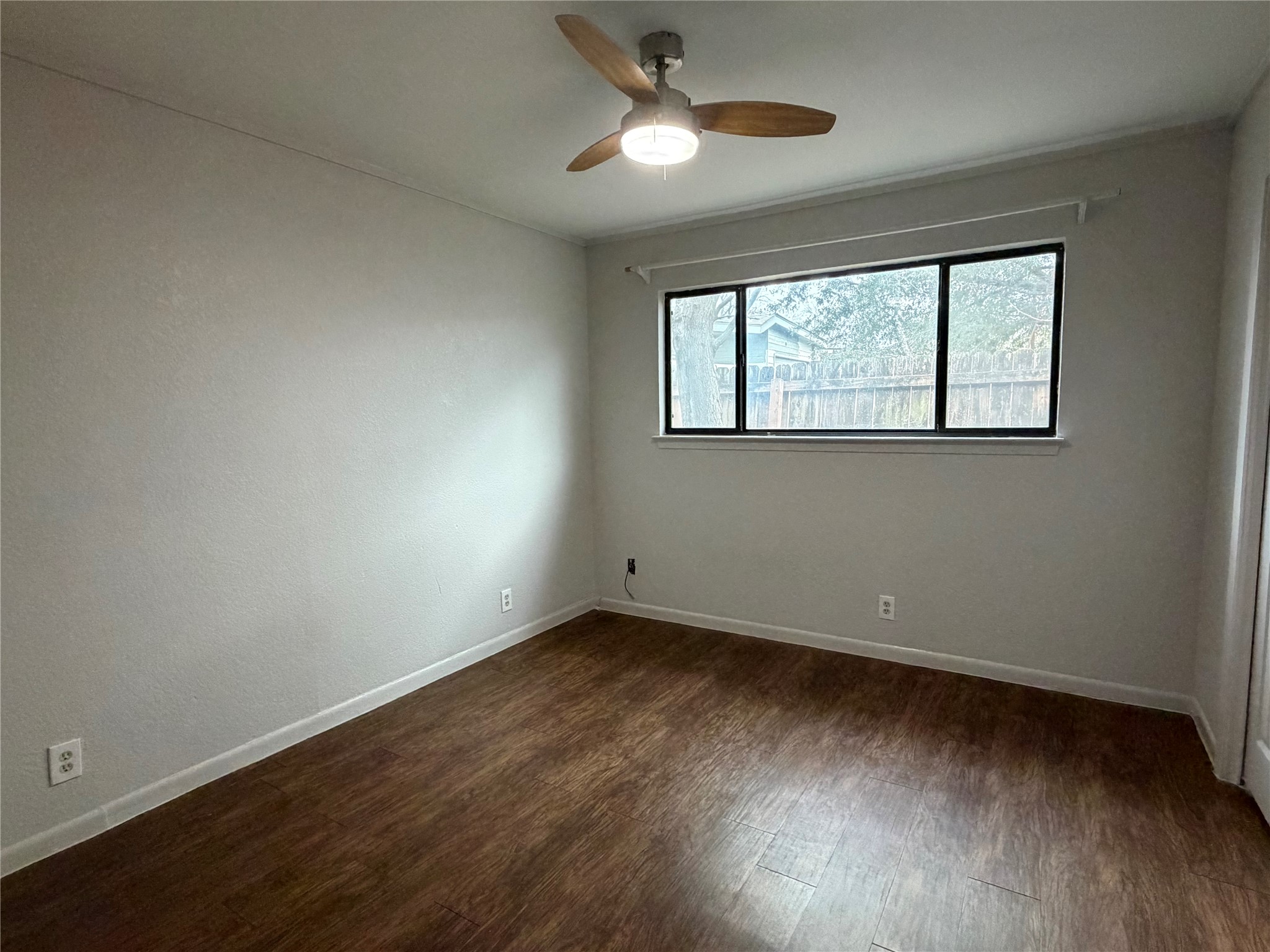 7404 Bethune Avenue, Unit B Austin, TX 78752 - Photo 12 of 13 Spare room featuring dark wood-type flooring and a ceiling fan
