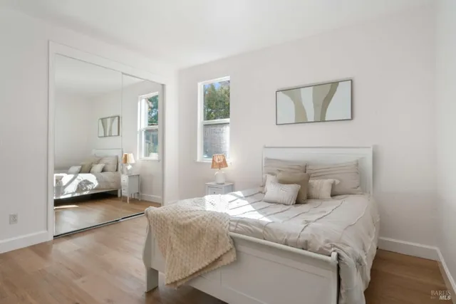 a bedroom with a bed and wooden floor