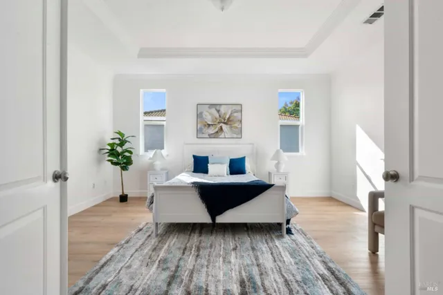 a bedroom with a bed wooden floor and window