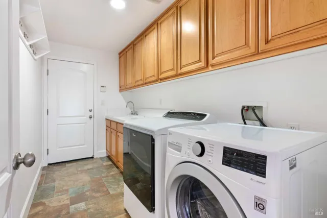 a kitchen with stainless steel appliances granite countertop a refrigerator a sink dishwasher a stove with wooden floor and cabinets