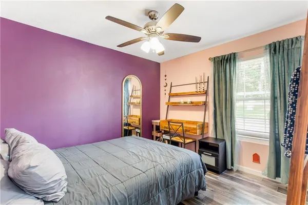 a bedroom with a bed and a large window with outer view