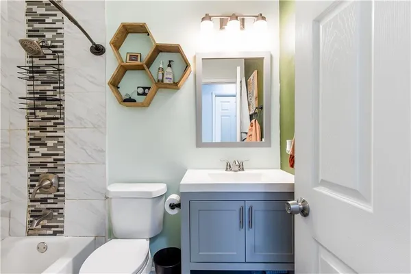 a bathroom with a sink mirror vanity and toilet