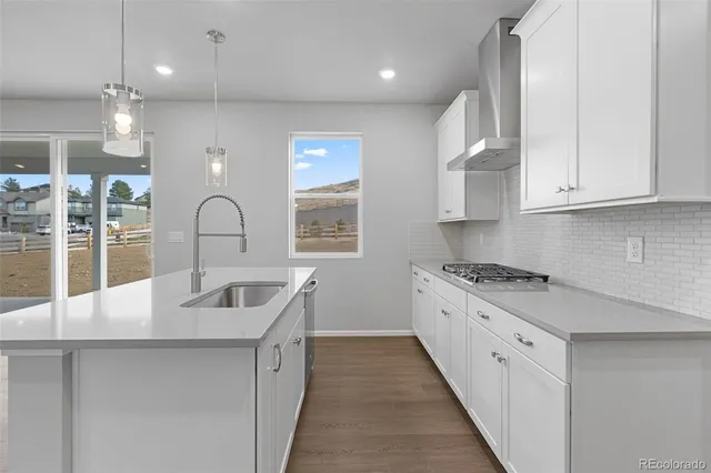 a kitchen with kitchen island granite countertop a sink stainless steel appliances and cabinets