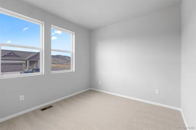 a view of an empty room and closet area