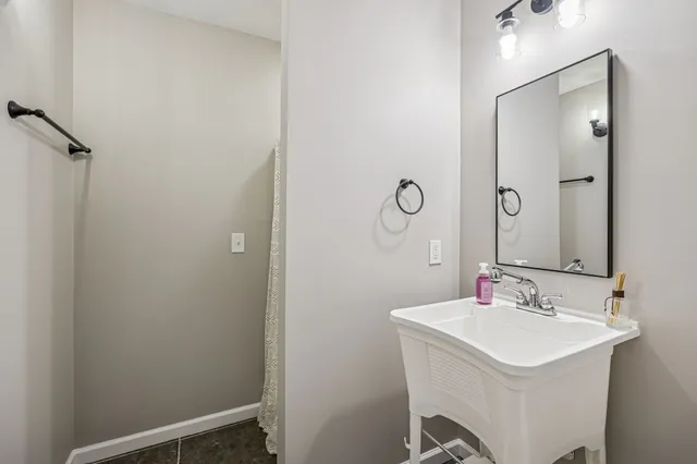 a bathroom with a sink mirror and vanity