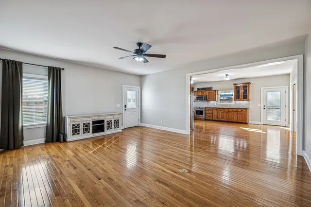 a view of a kitchen with furniture wooden floor and a window