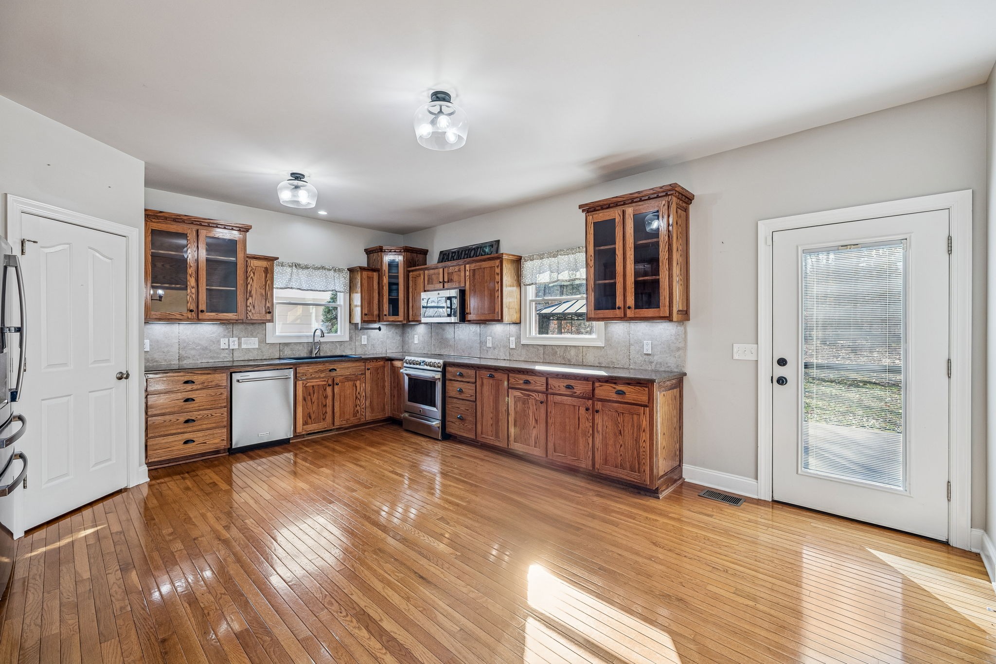 3840 East Compton Road Murfreesboro, TN 37130 - Photo 9 of 51 a large kitchen with stainless steel appliances granite countertop a large counter top and a wooden floors