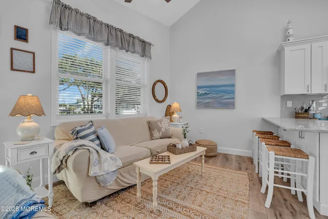 a living room with furniture chess table and a window