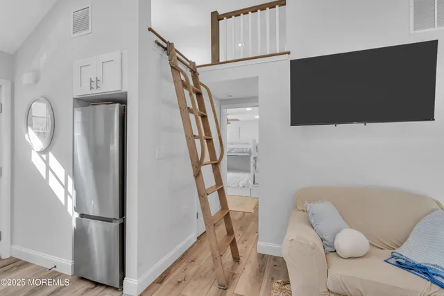 a view of entryway with furniture and wooden floor