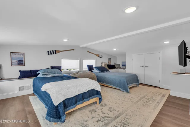 a bedroom with a large bed and a chandelier