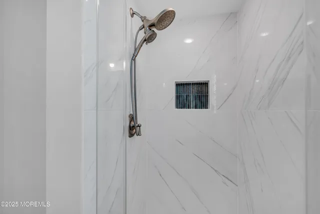 a bathroom with a shower and a glass door