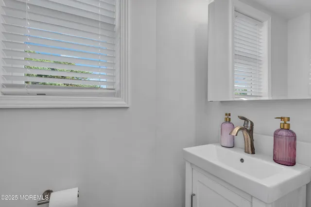 a bathroom with a sink and vanity