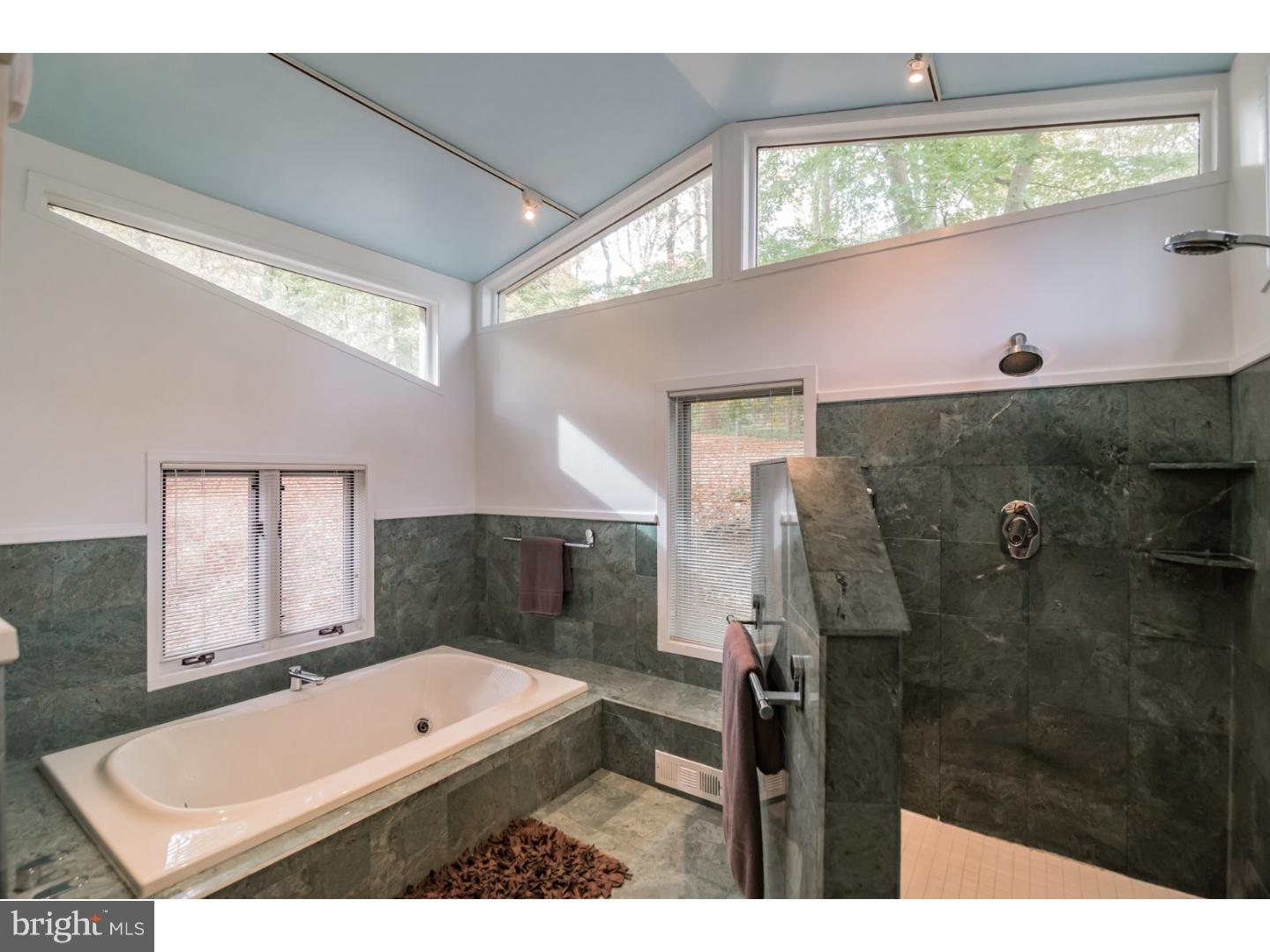 356 Pugh Road Wayne, PA 19087 - Photo 18 of 25 a bathroom with a tub a sink and a window