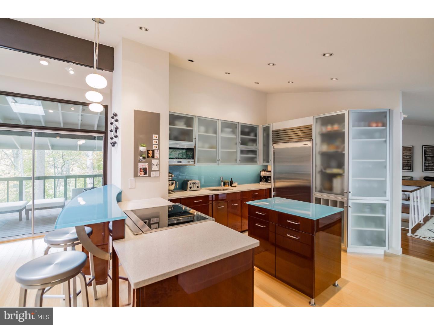 356 Pugh Road Wayne, PA 19087 - Photo 7 of 25 a kitchen with stainless steel appliances kitchen island granite countertop a table and chairs