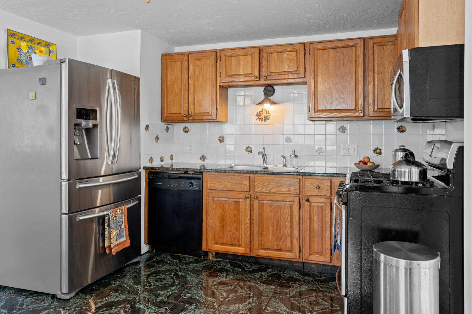 9 Sampson Avenue Edgartown, MA 02539 - Photo 7 of 35 a kitchen with stainless steel appliances granite countertop a refrigerator stove and sink