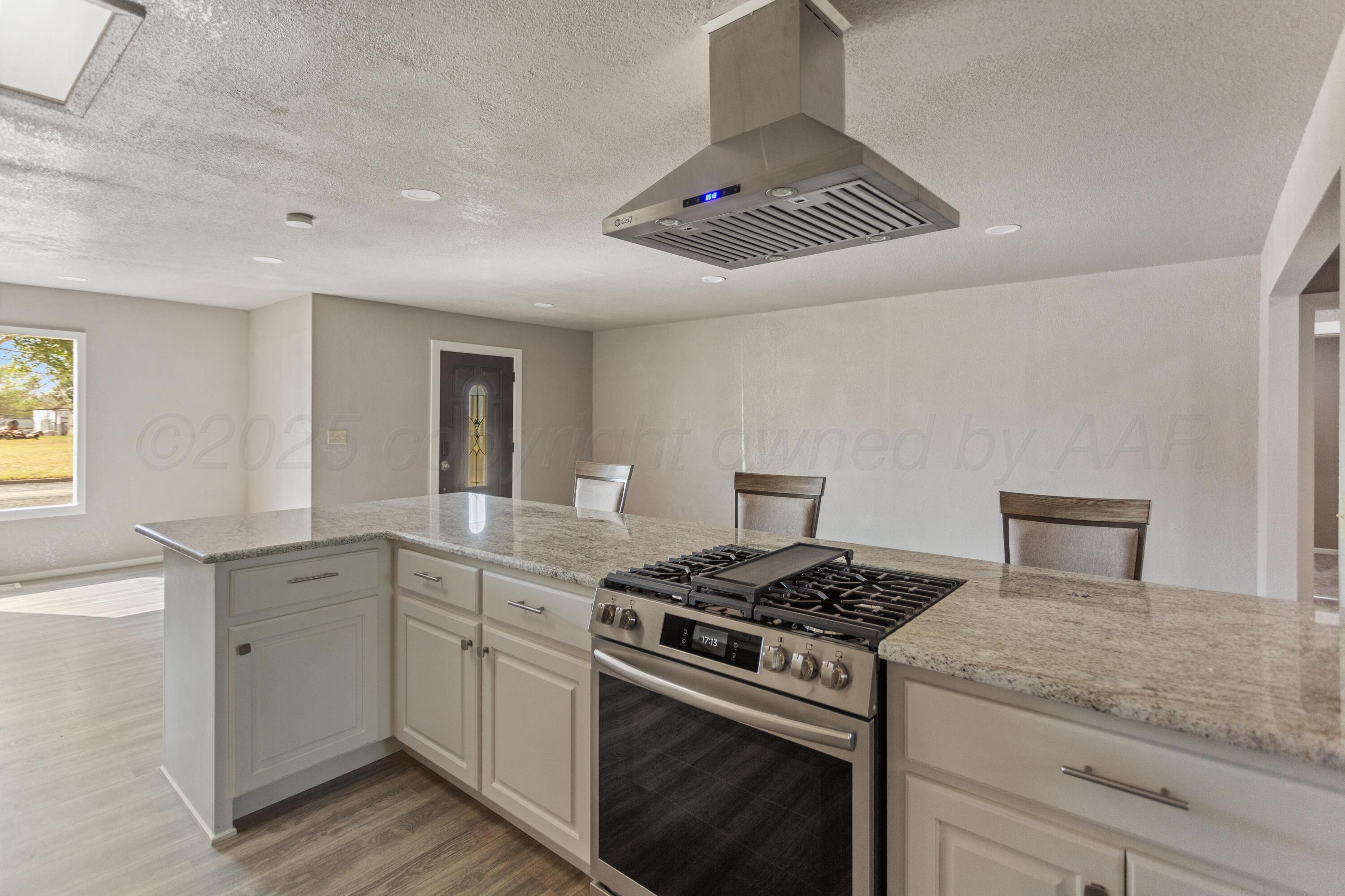 1119 South Main Street Wheeler, TX 79096 - Photo 11 of 49 a kitchen with a stove cabinets and window