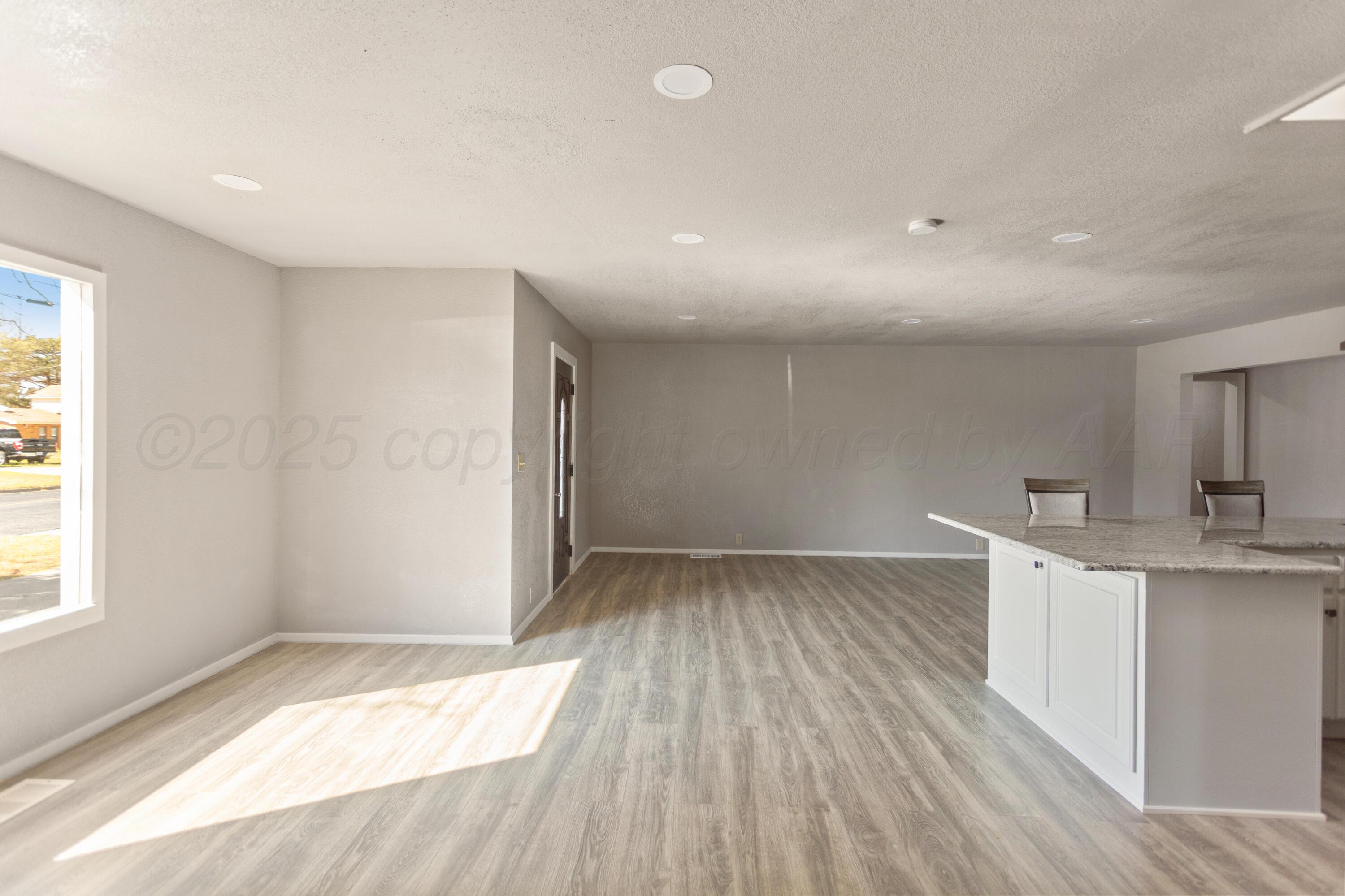 1119 South Main Street Wheeler, TX 79096 - Photo 16 of 49 a view of wooden floor and windows in a room