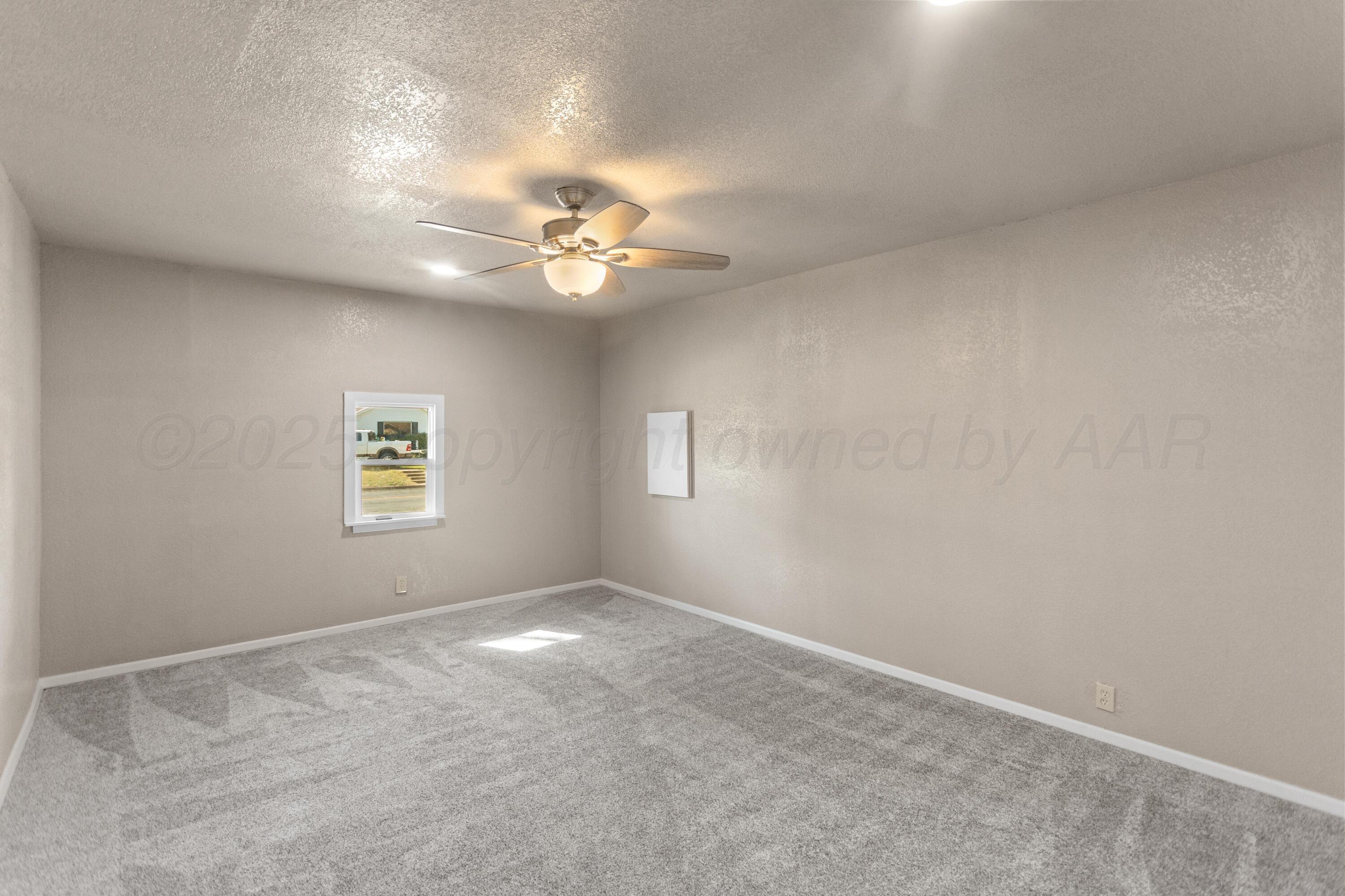 1119 South Main Street Wheeler, TX 79096 - Photo 19 of 49 an empty room with a fan & a window