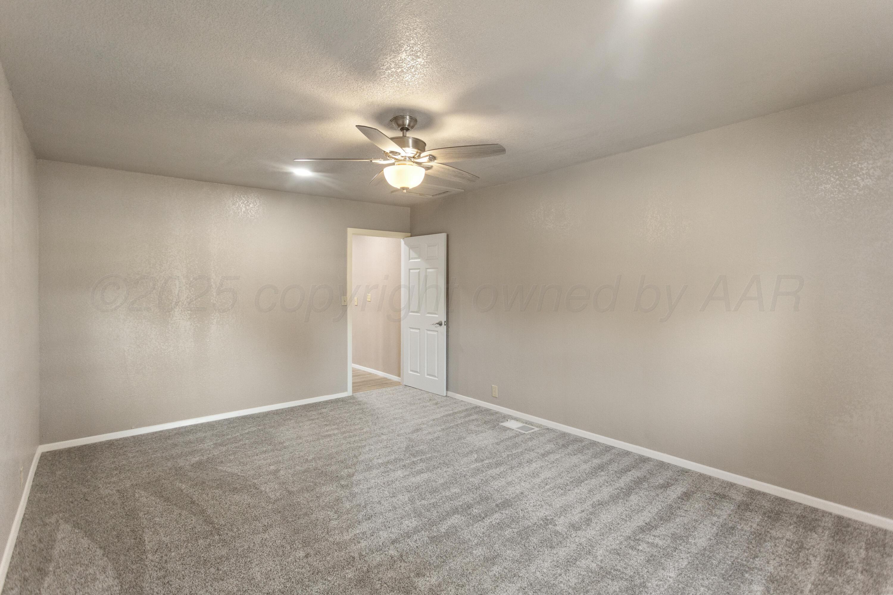 1119 South Main Street Wheeler, TX 79096 - Photo 20 of 49 an empty room with windows and fan