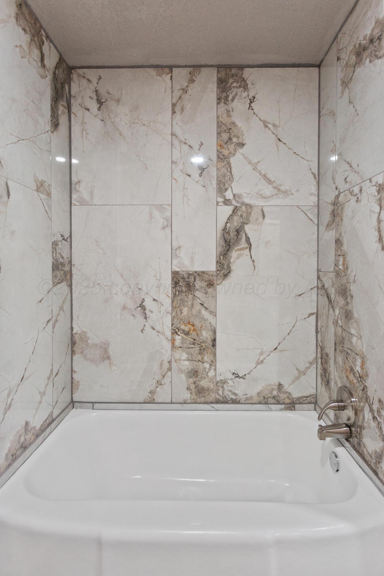 1119 South Main Street Wheeler, TX 79096 - Photo 27 of 49 a bathroom with a bathtub and shower