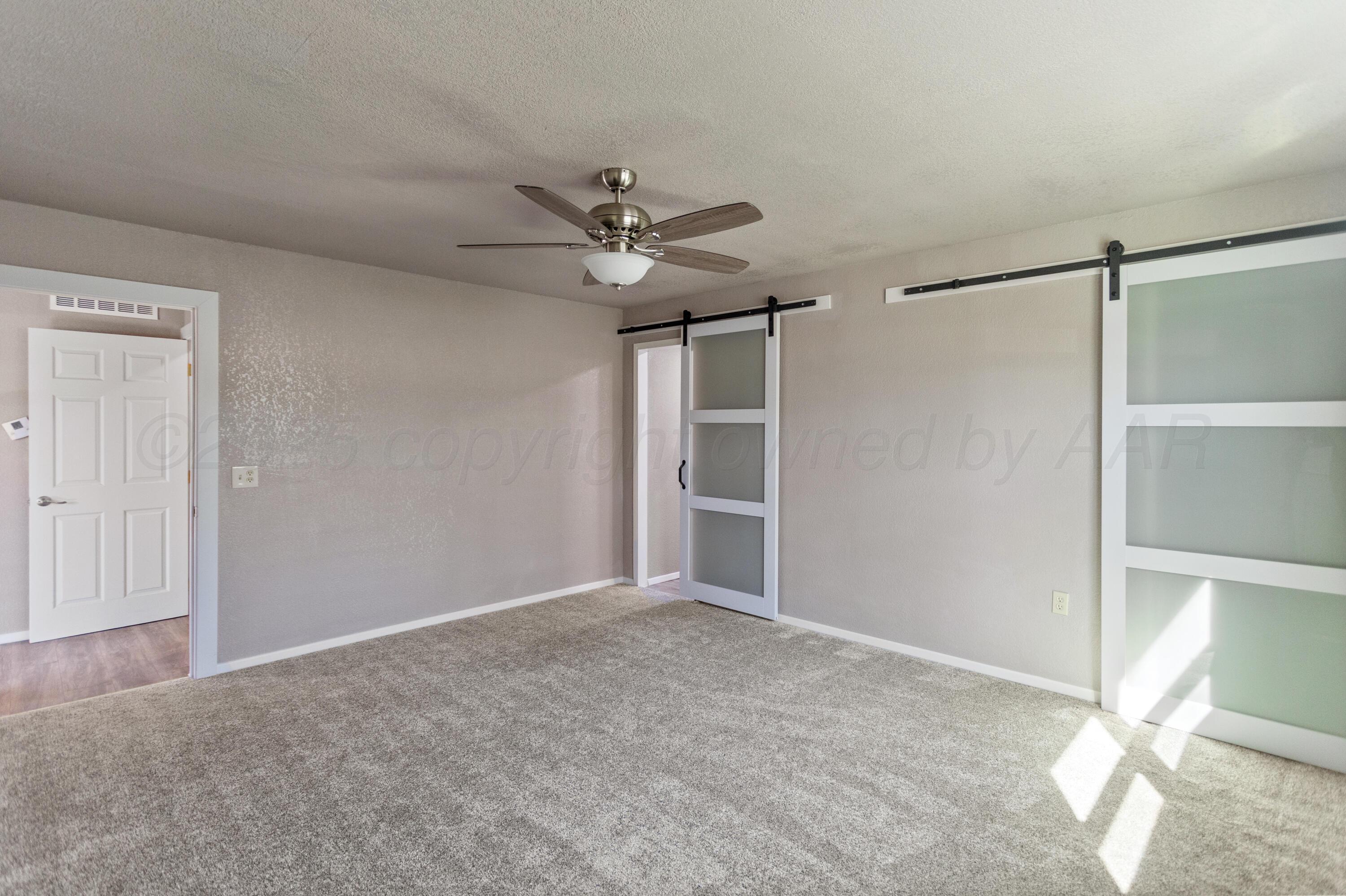 1119 South Main Street Wheeler, TX 79096 - Photo 29 of 49 a view of an empty room with a ceiling fan