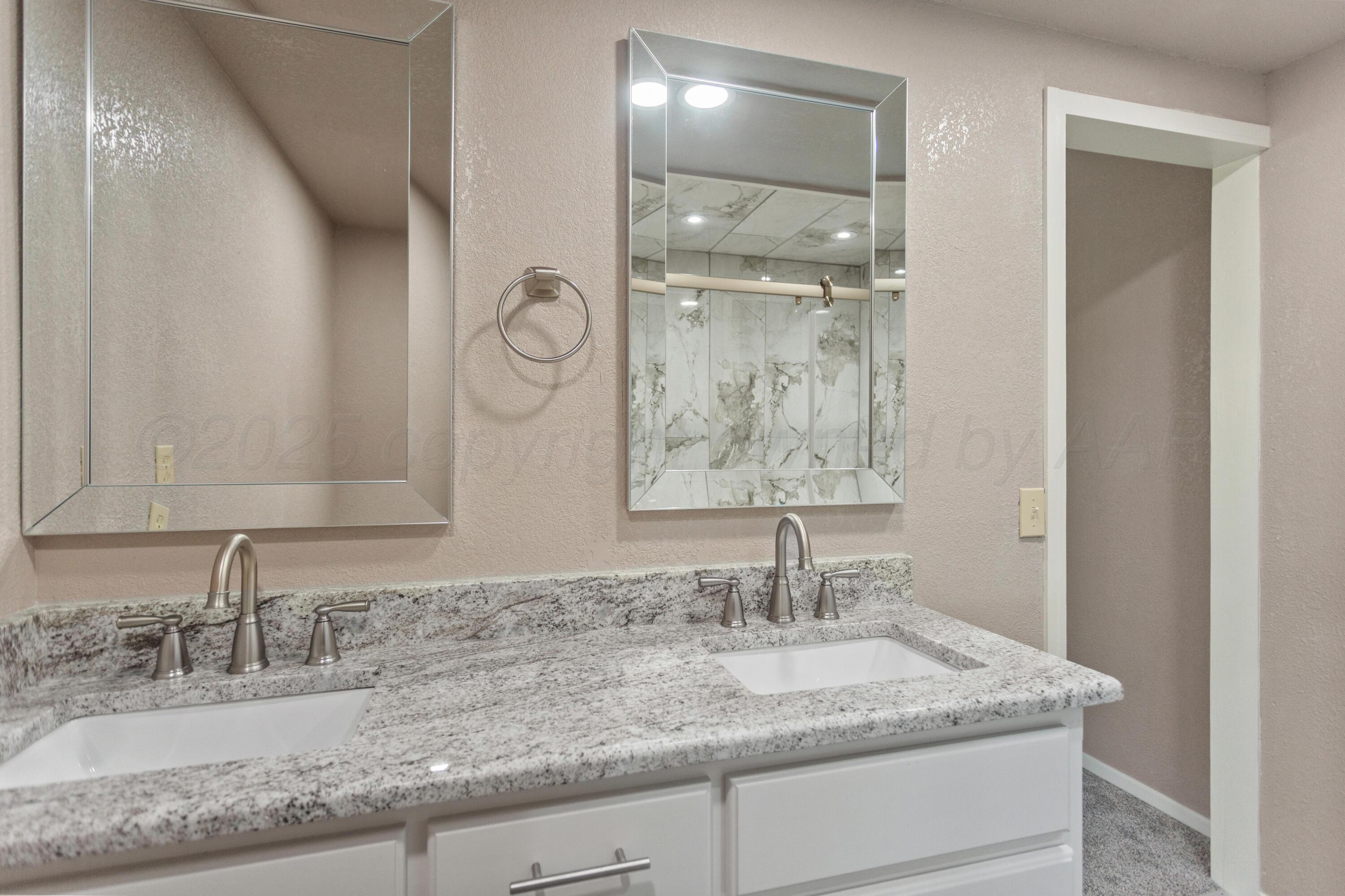 1119 South Main Street Wheeler, TX 79096 - Photo 33 of 49 a bathroom with a granite countertop sink and a mirror