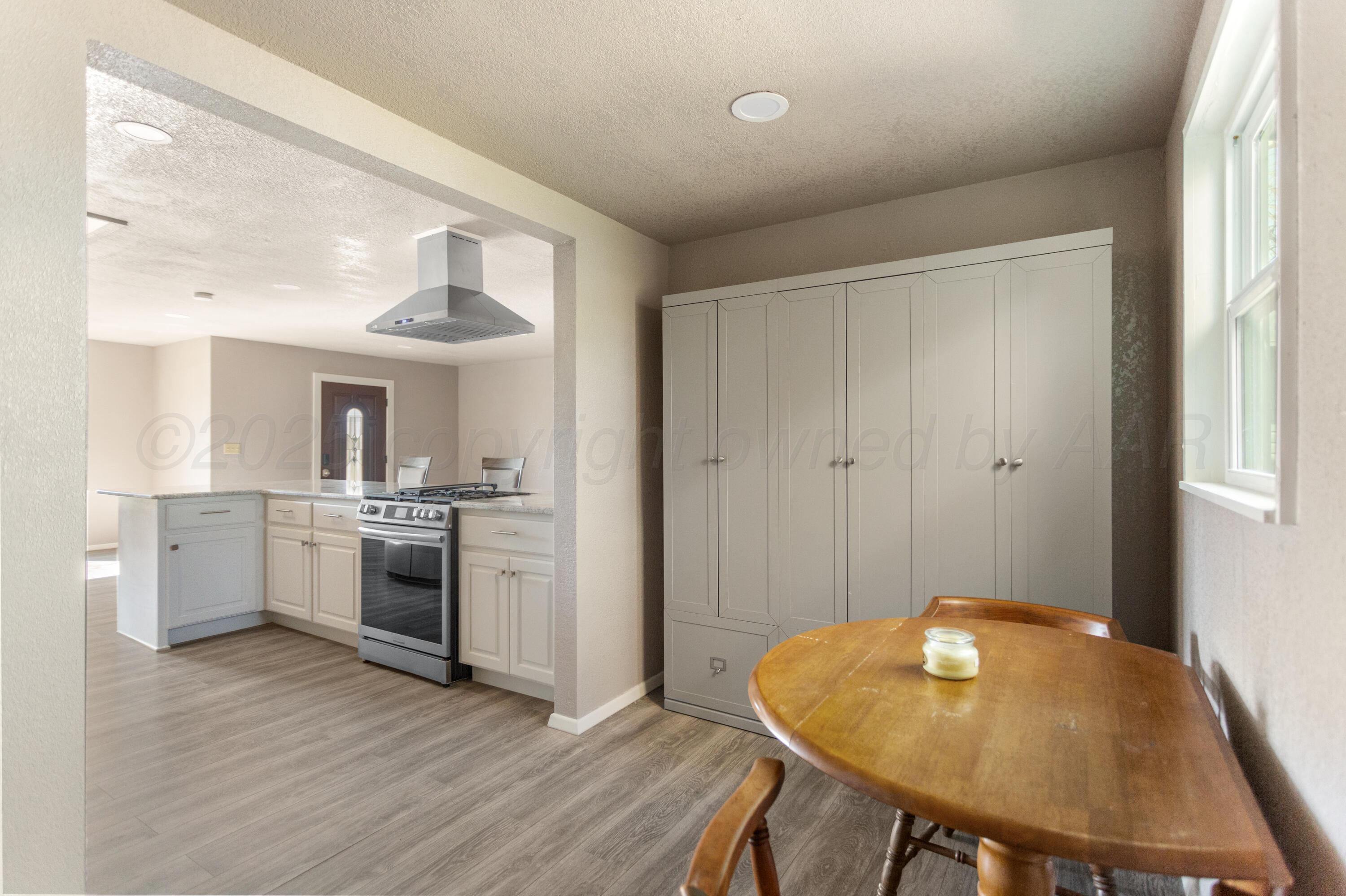 1119 South Main Street Wheeler, TX 79096 - Photo 36 of 49 a view of a kitchen area with furniture and wooden floor