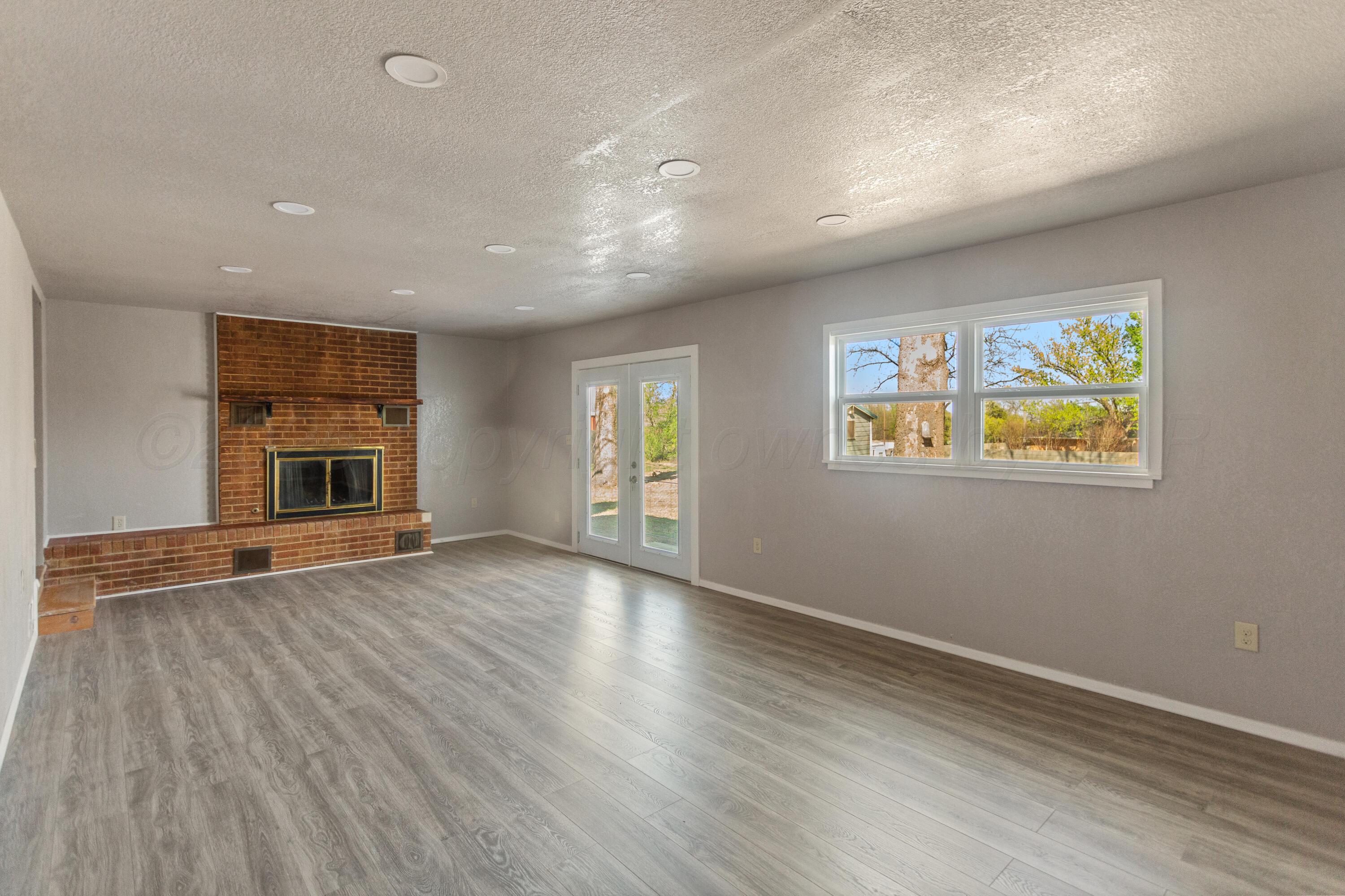1119 South Main Street Wheeler, TX 79096 - Photo 39 of 49 an empty room with windows and fireplace