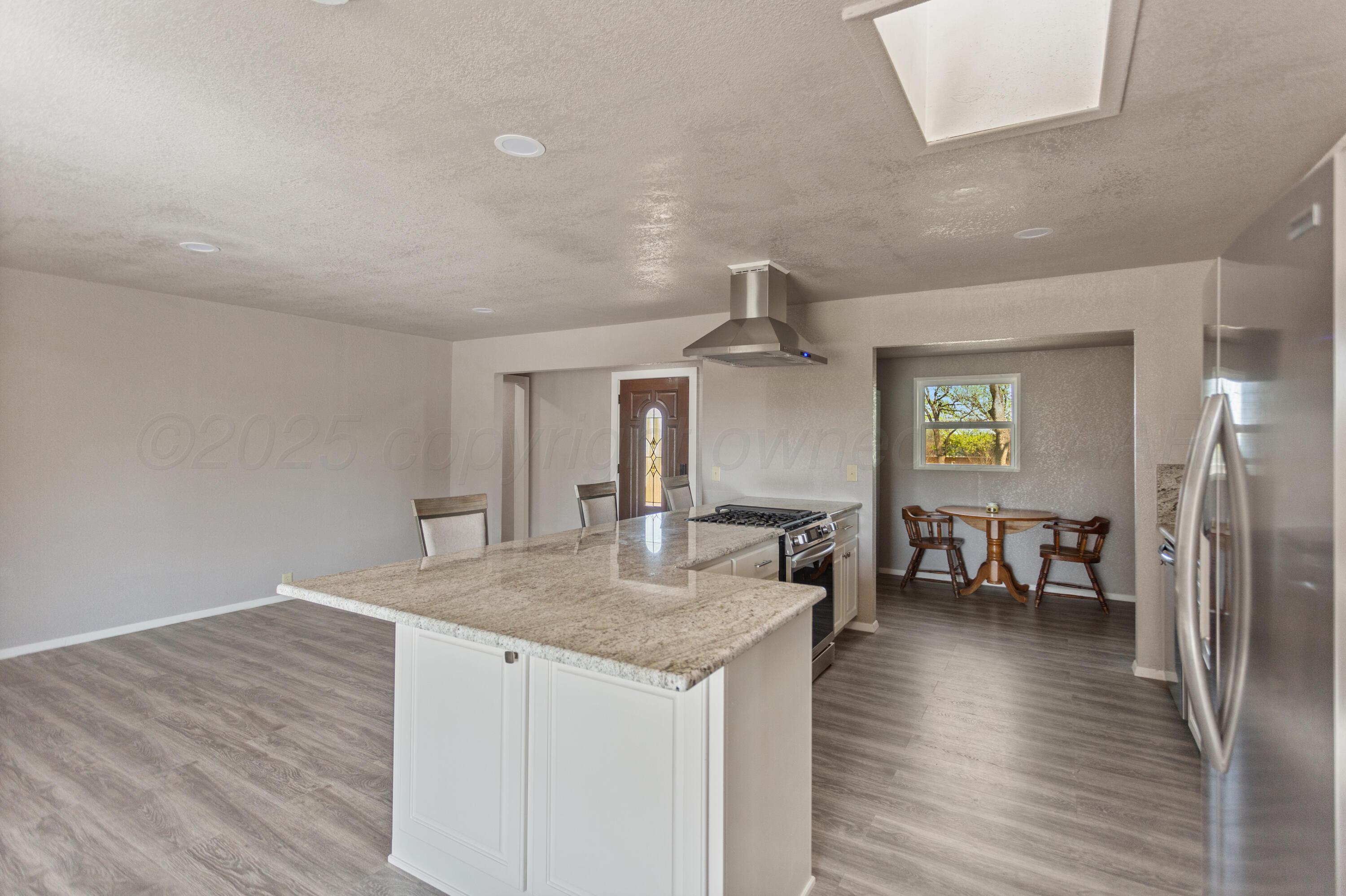 1119 South Main Street Wheeler, TX 79096 - Photo 8 of 49 a kitchen with stainless steel appliances granite countertop a sink and stove