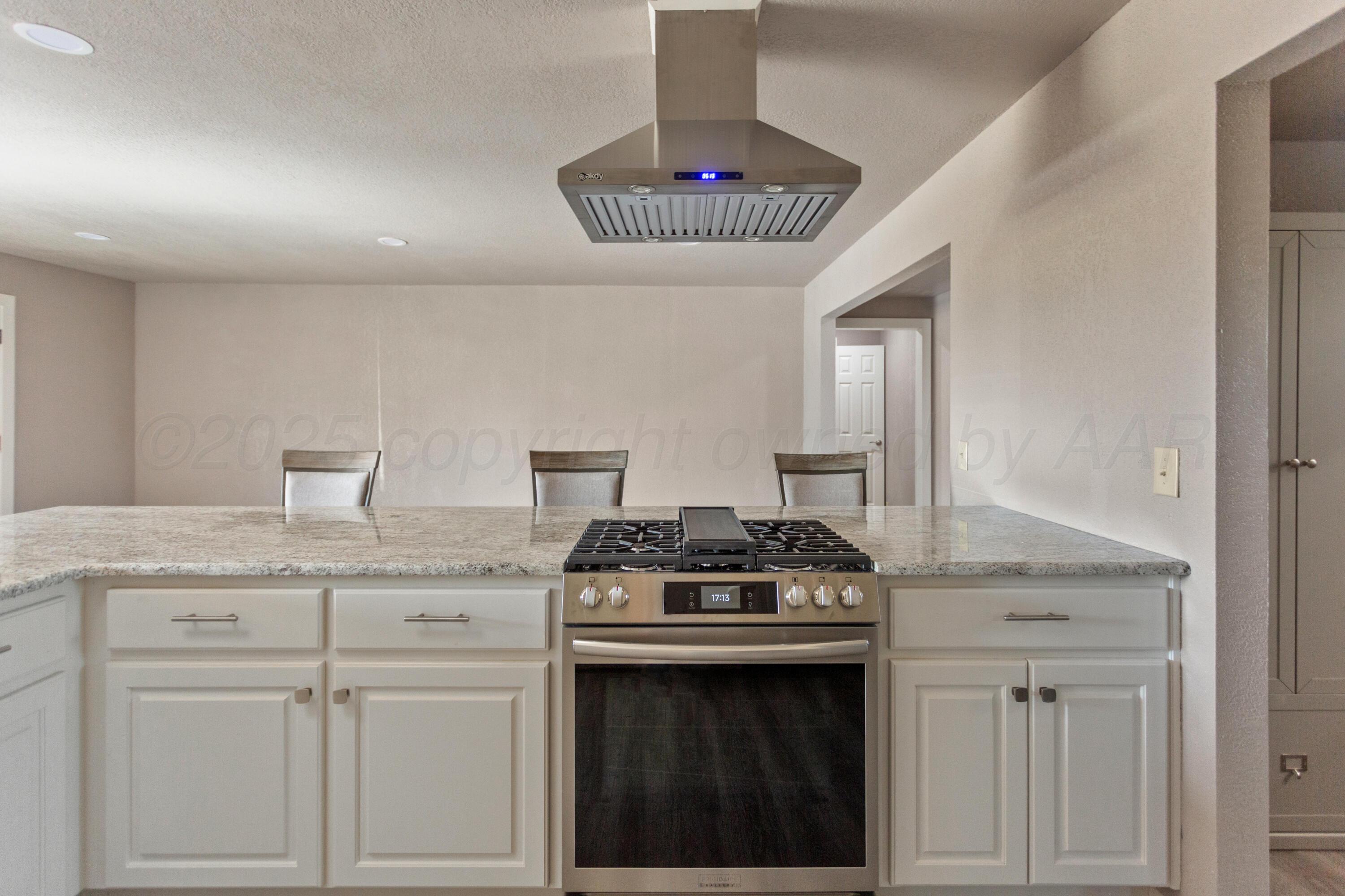 1119 South Main Street Wheeler, TX 79096 - Photo 10 of 49 a kitchen with granite countertop a stove and a sink